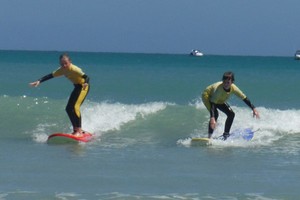 siblings learning their surf lessons