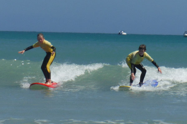 siblings learning their surf lessons